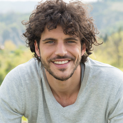 Man with curly hair and smile